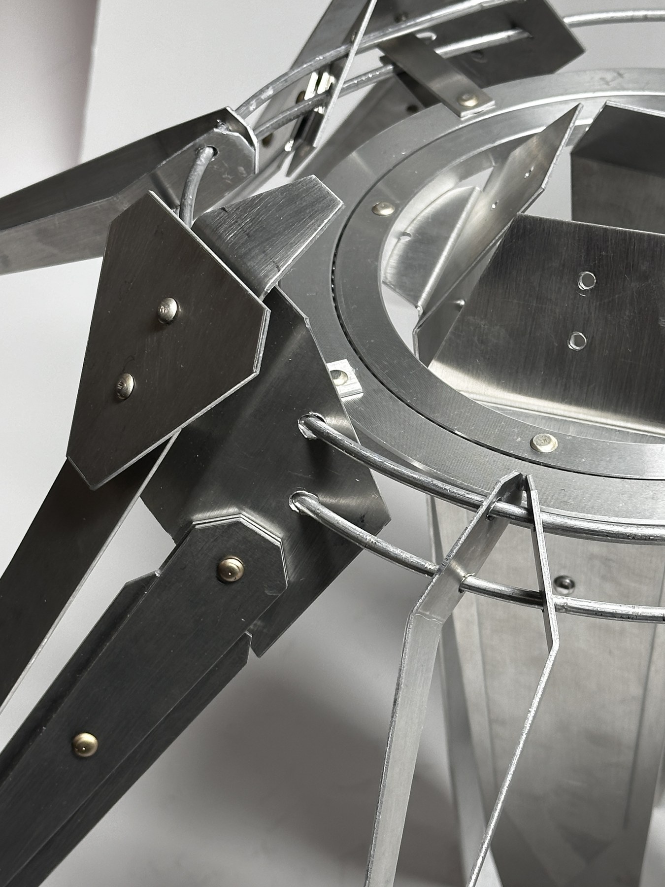 Detailed view of mechanical fasteners, folded plates, rods, and ring connections
