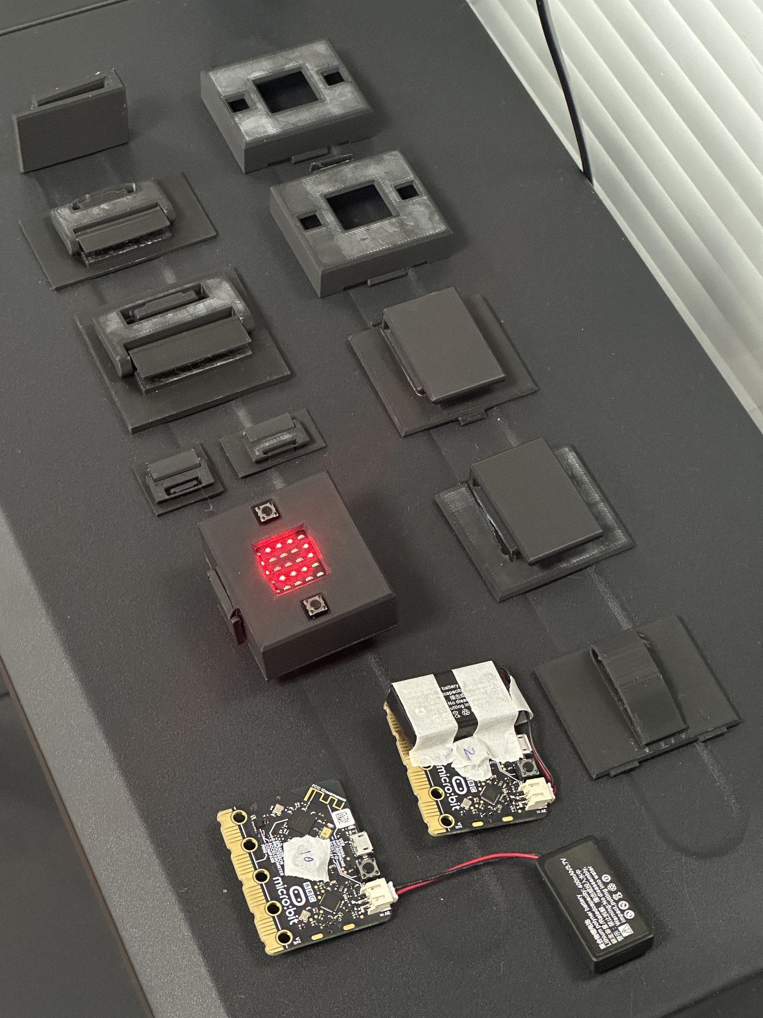 Multiple 3D-printed wearable audio module enclosure iterations with electronics