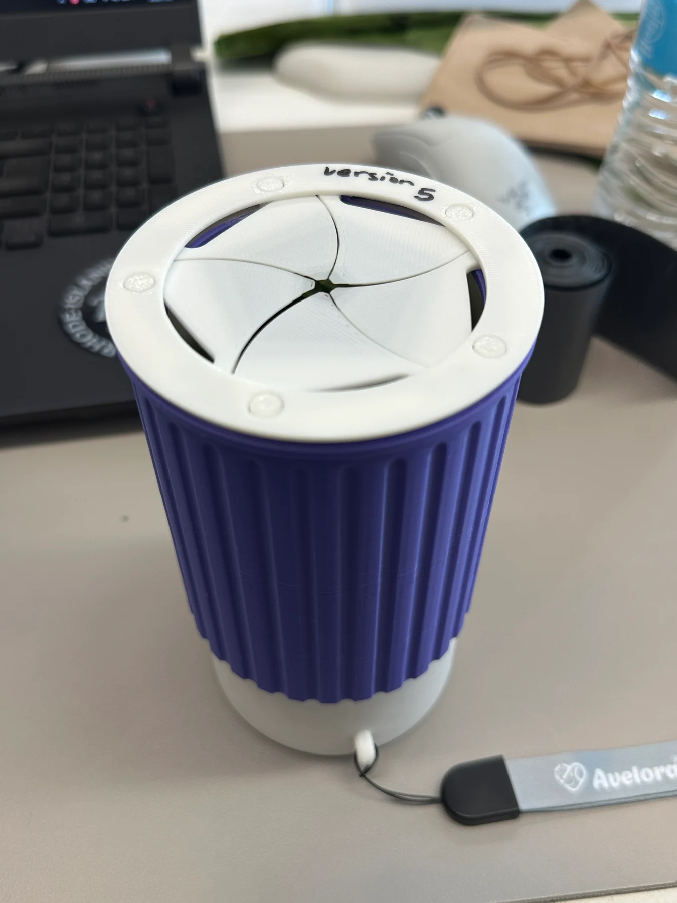 Close view of the latest physical prototype's five-blade aperture and ribbed purple sleeve