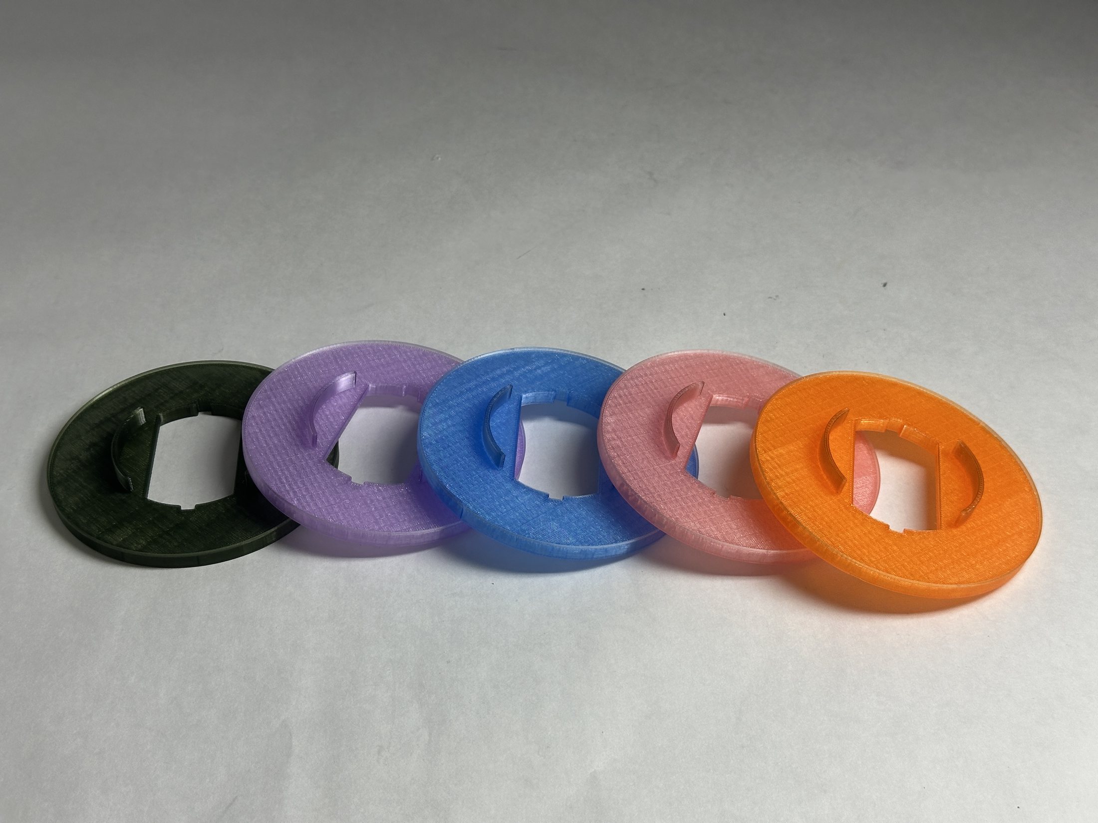 Five coloured 3D-printed filter variants shown together