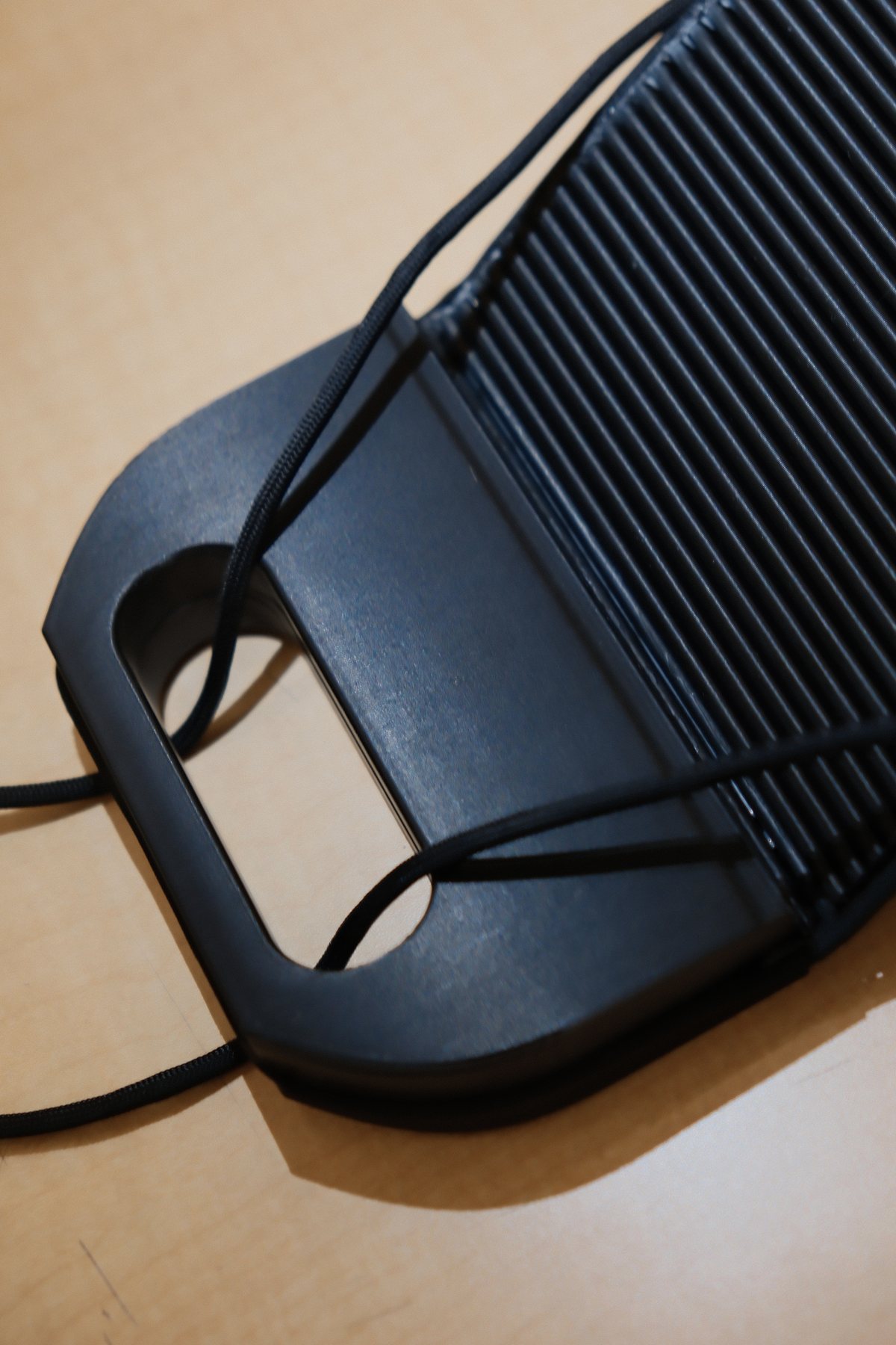 Close view of the flexible tambour-style wing and tension cord
